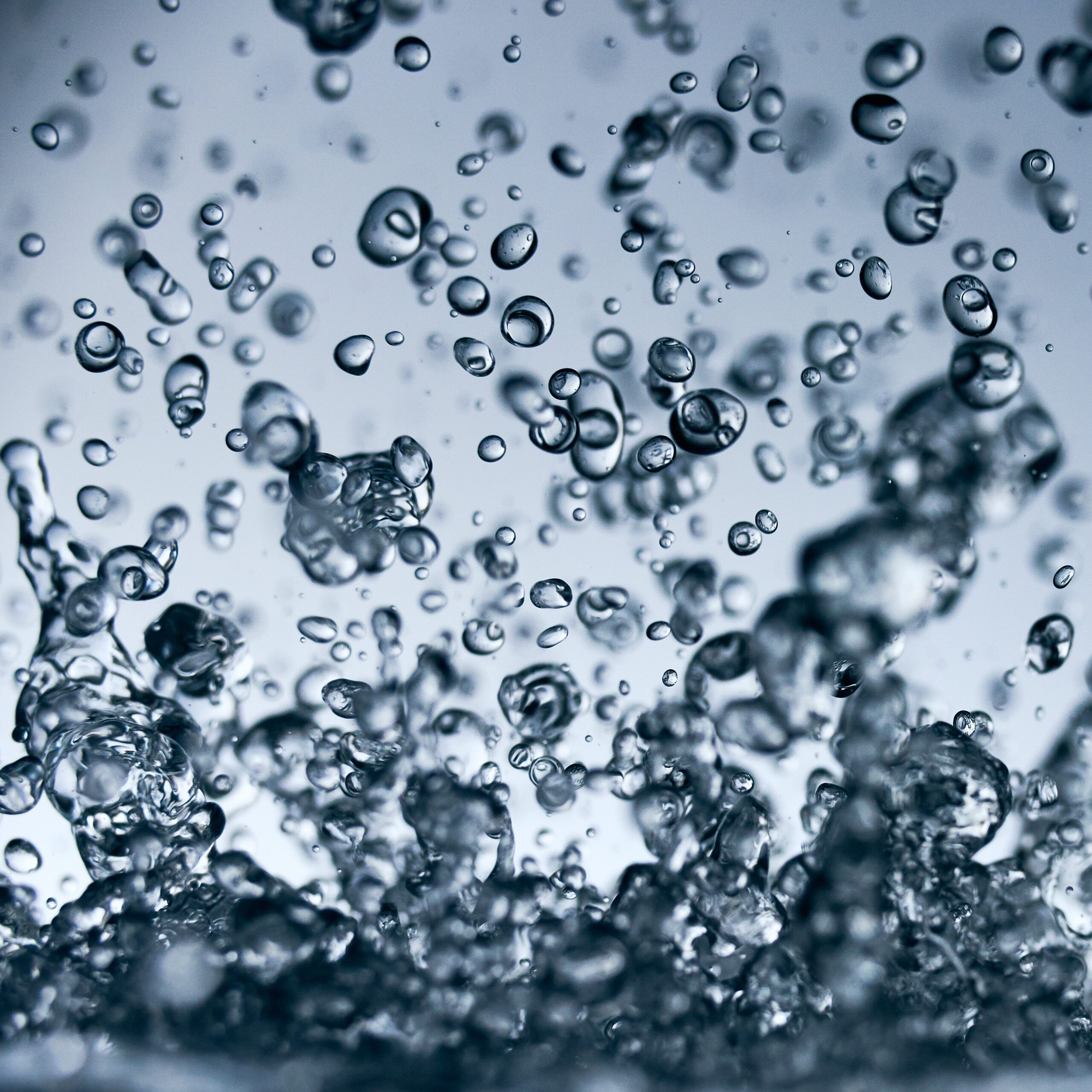 abstract falling drops of water on a light background close-up